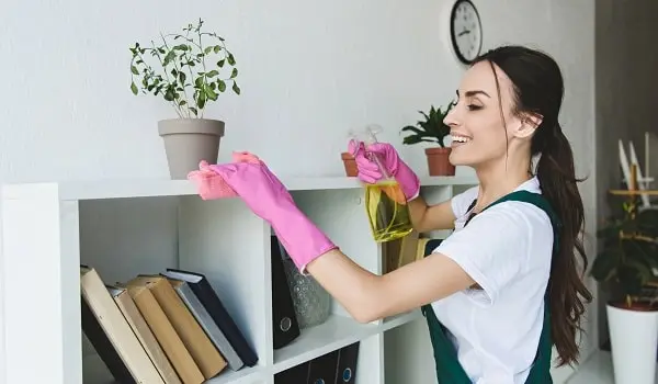 A Keva's cleaner dusting with a smile